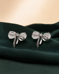 Silver bow stud earrings portrait product view