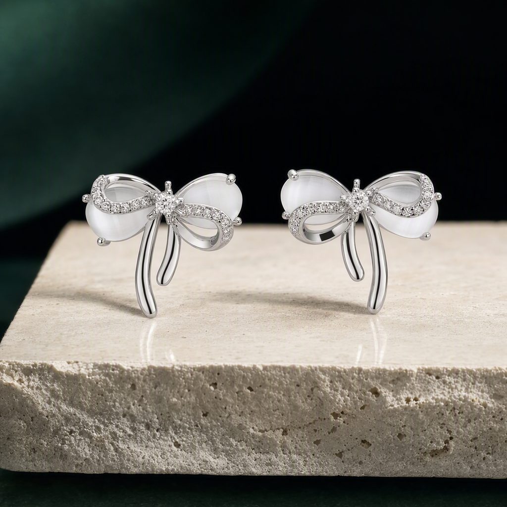 Silver bow stud earrings square product view