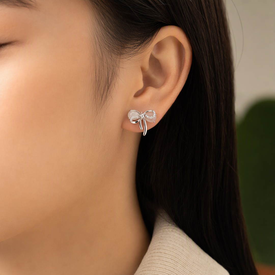 Silver bow stud earrings styled view